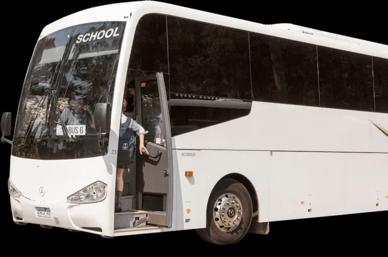 A school bus driver at the wheel of a RollCall-equipped bus